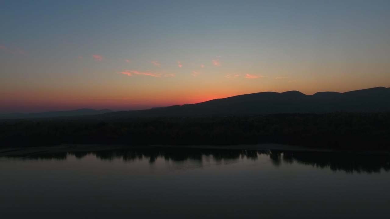 Aerial shot with rising view of a sunset, or sunrise