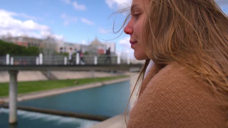 close up gimbal shot of woman enjoying sun in cold and windy day