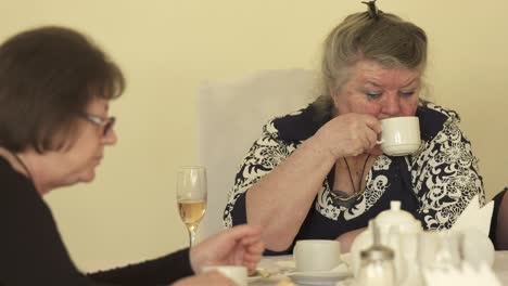 senior citizens at festive dinner eating cake