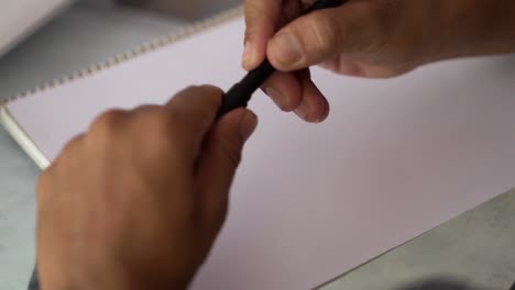 beard man writing letter with pen and paper on the table