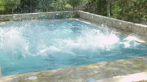 Group-Of-Friends-On-Vacation-Jumping-Into-Outdoor-Pool