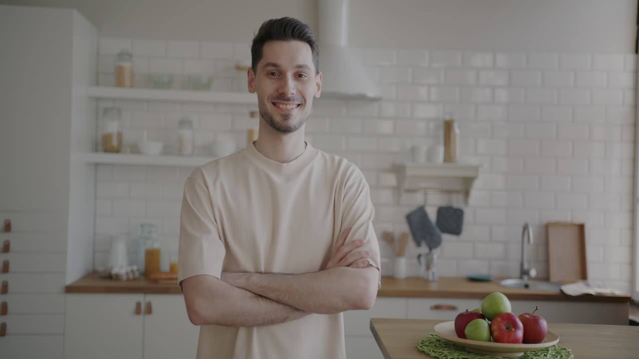 Man smiling in a kitchen