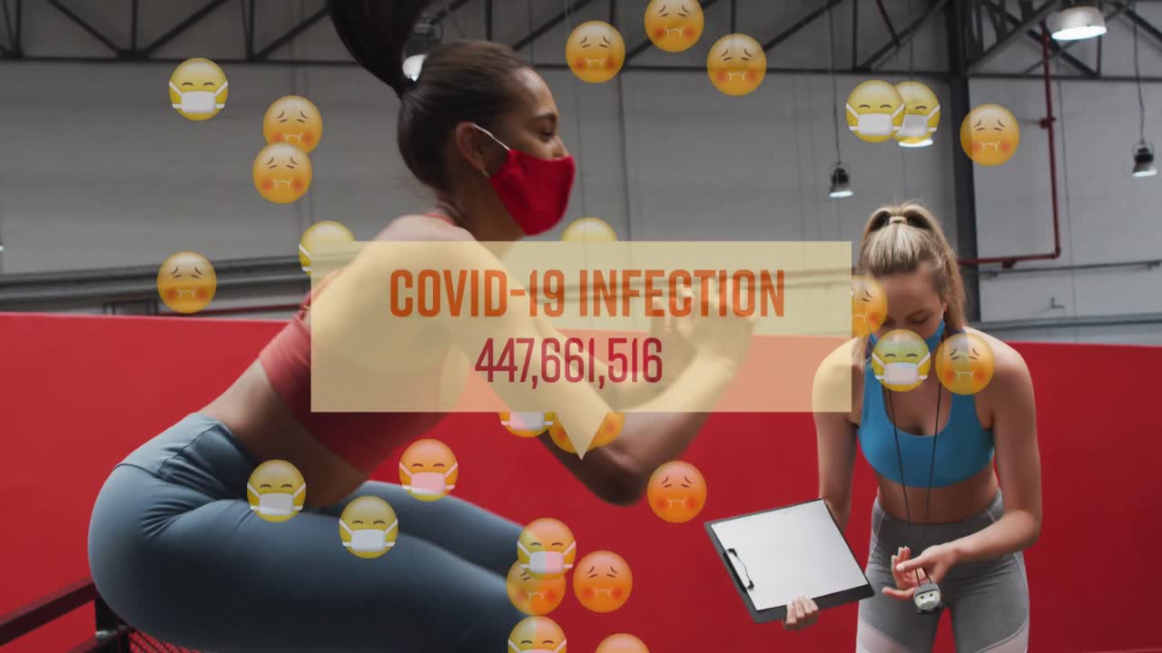 Animation of words covid-19 infections and emojis over women wearing face masks working out