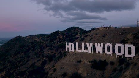 the iconic hollywood sign on a hill at dusk