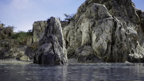 natural rock formation rising from calm water in a serene landscape