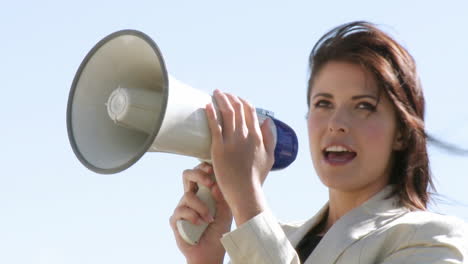 businesswoman giving instruction via megaphone 2