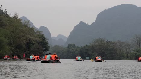 tourists rowing boats through scenic mountains