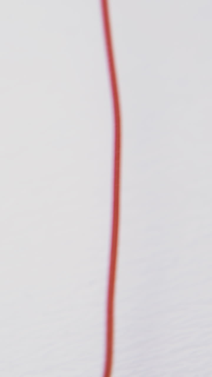 motion along thin assorted tangled electric wires heap lying on empty white background extreme close view