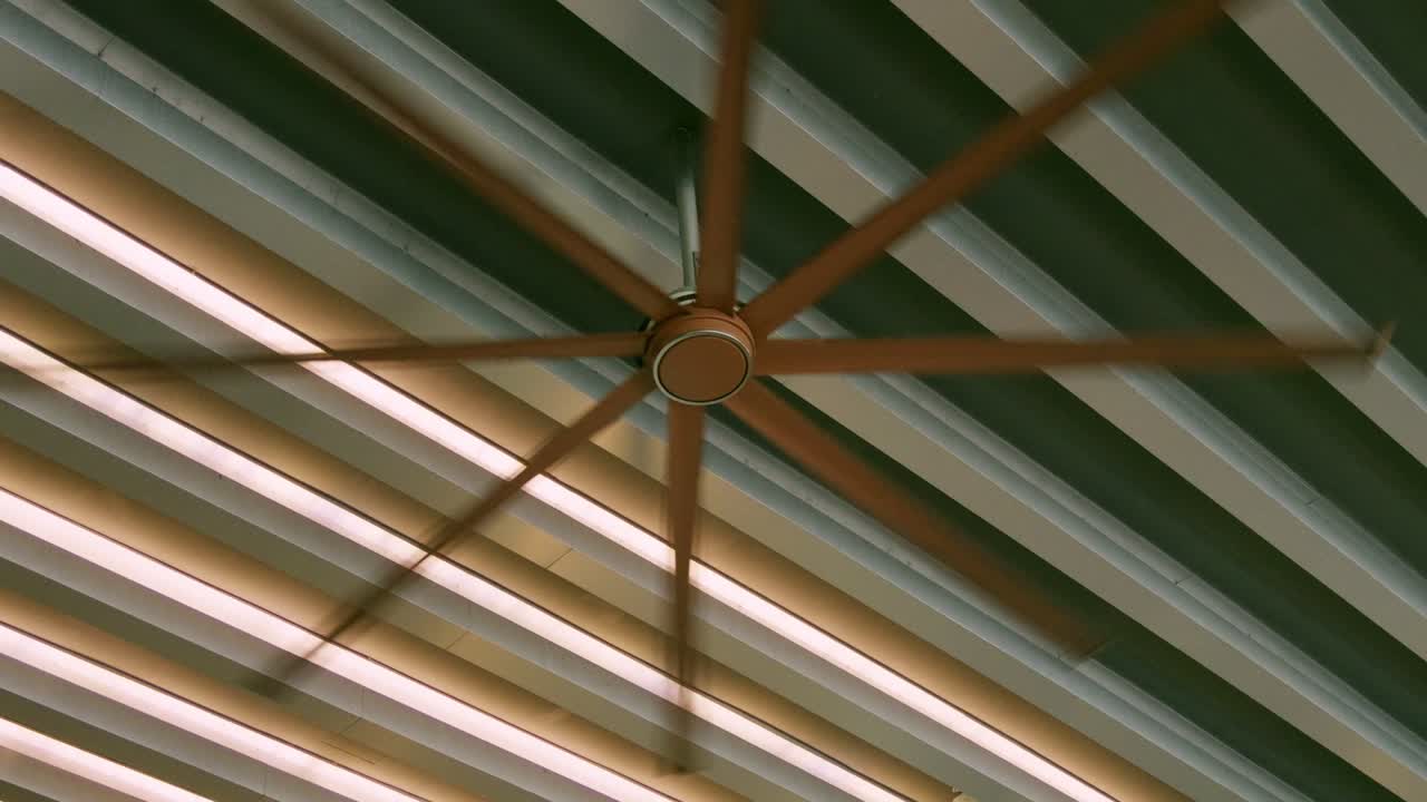 Un ventilatore a soffitto dinamico gira in alto migliorando l'atmosfera moderna di un elegante design d'interni