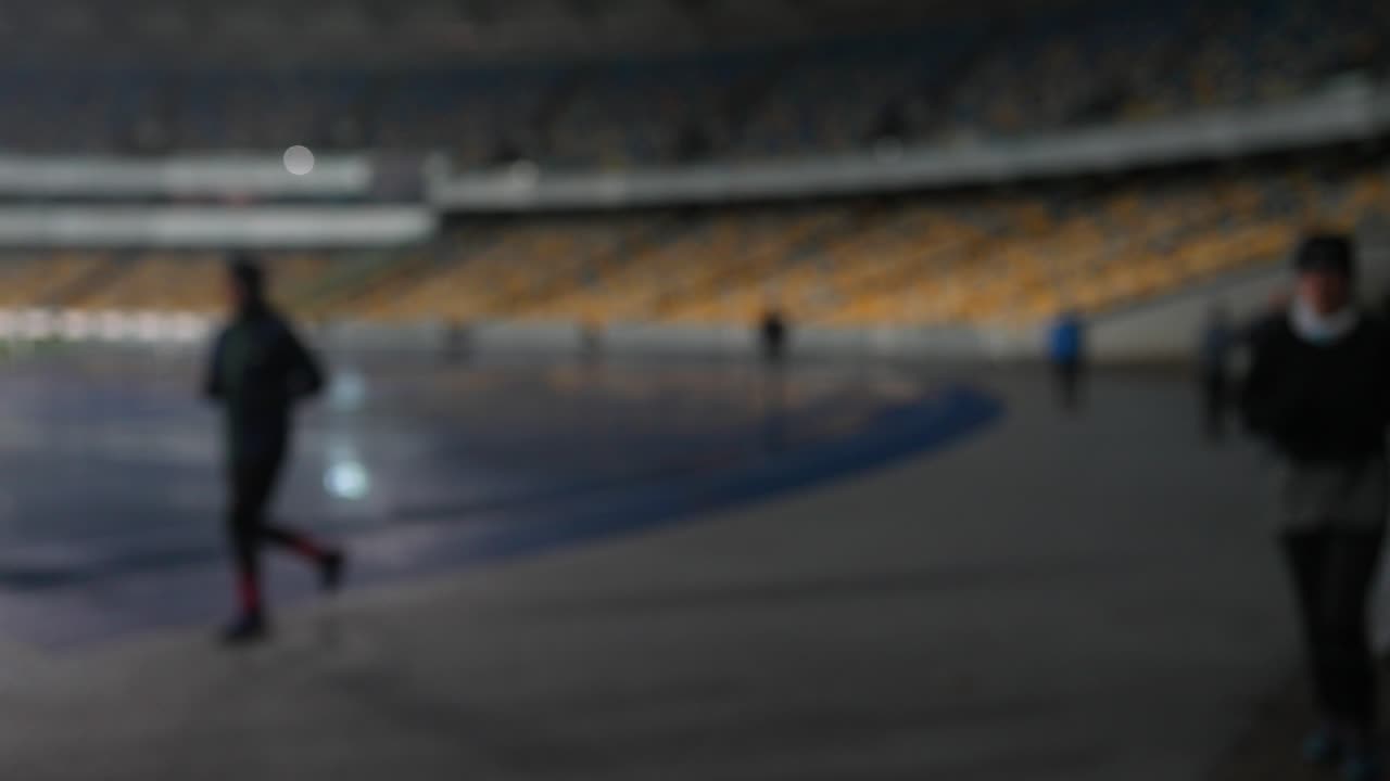 personas corriendo en un estadio por la noche