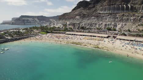 View-of-the-turquoise-ocean-and-white-sand-on-the-beach-Playa-de-Amadores,-aerial