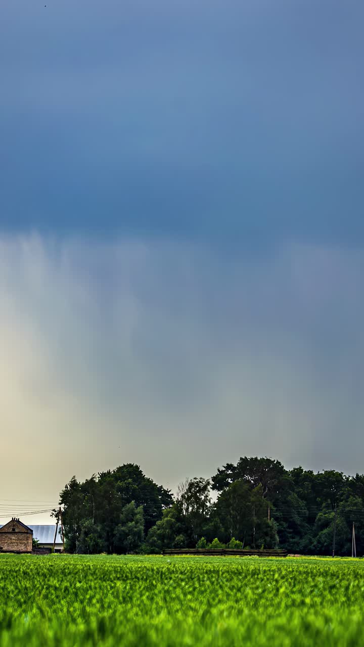 White clouds develop in a blue sky over a green landscape