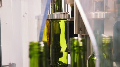 red wine being bottled in a factory production line