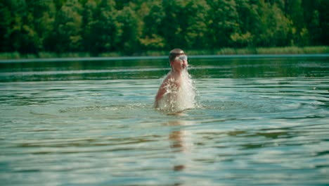 View-of-a-water-outburst-while-kid-get-up-and-sink-in-afresh-lake-water