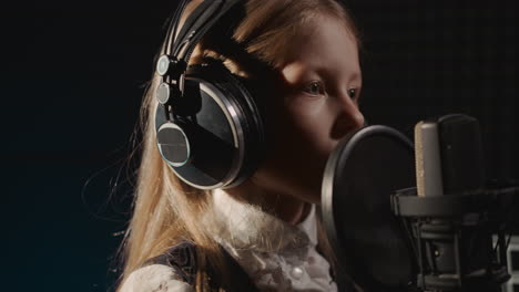 young girl singing in a recording studio