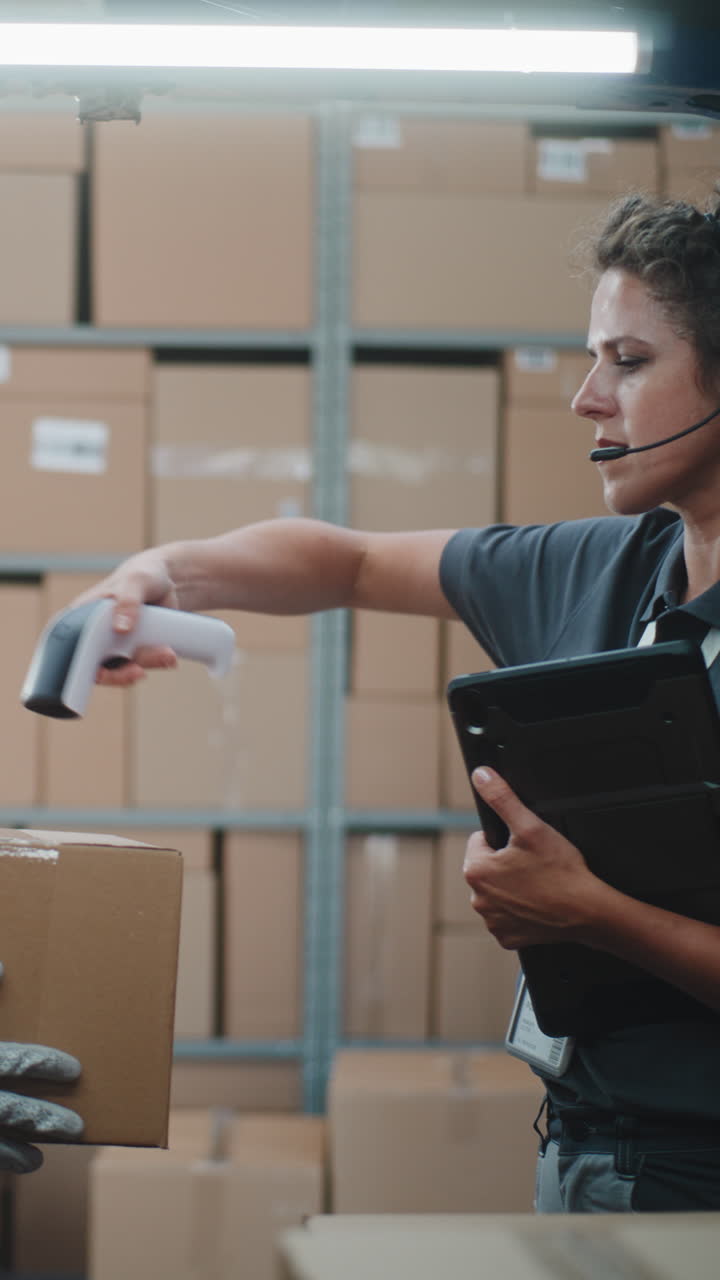 Woman working in a warehouse, scanning packages and managing inventory