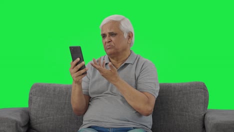 Indian-old-man-talking-on-video-call-Green-screen