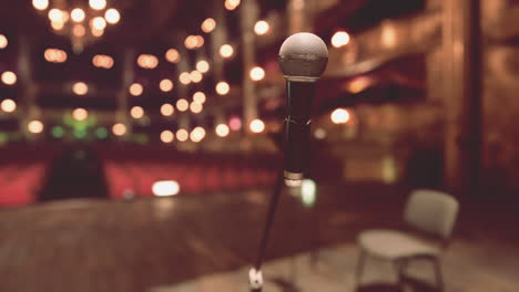 a microphone on a stage with a blurred background of lights