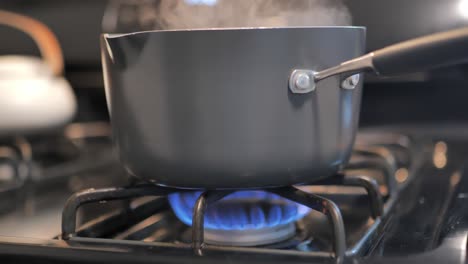 evaporating mist coming out of pot on top of a stove