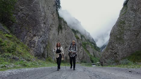 hikers checking map in a misty mountain valley