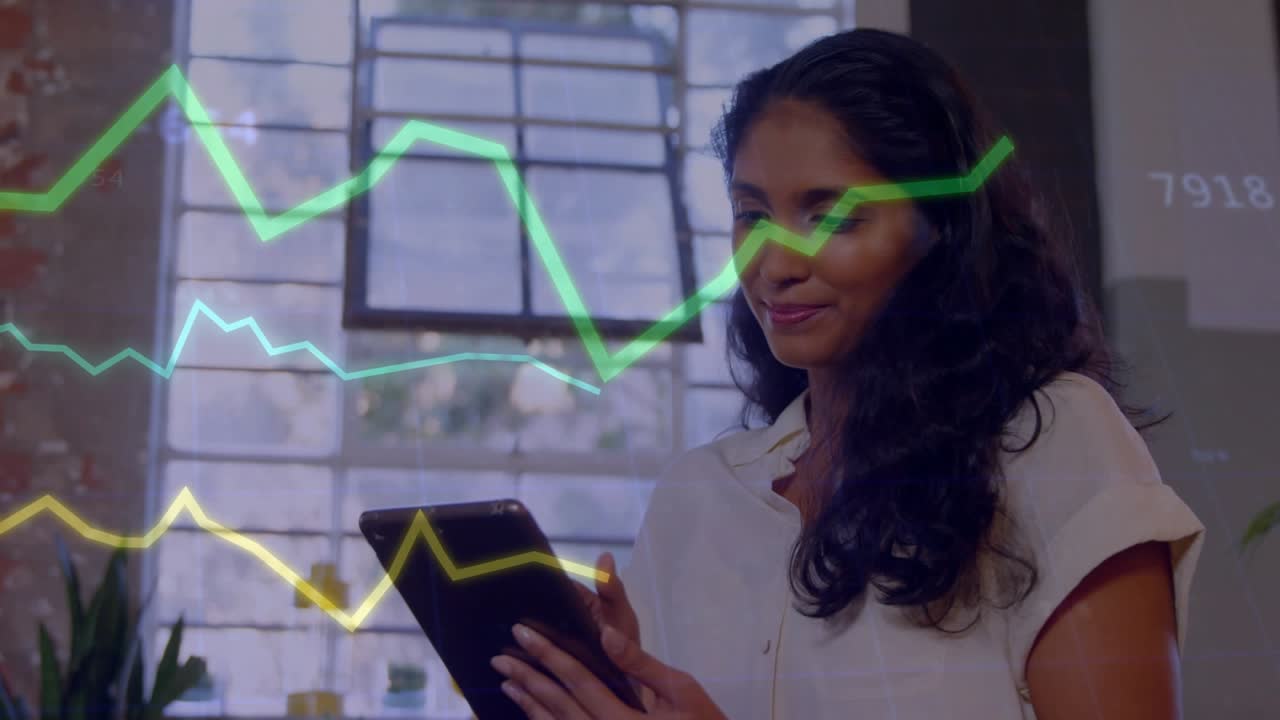 Businesswoman tapping tablet, causing finance graphs sweeping across window while analyzing data