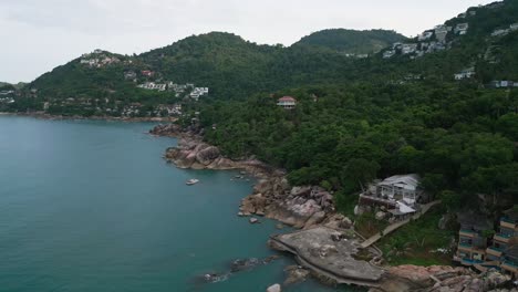 blue cliff bay in green tropical jungle, aerial fly koh samui coral cove beach thailand's travel natural resort coastal village