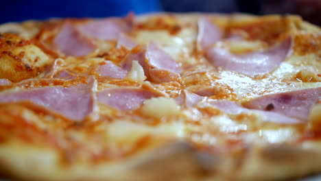 Hawaiian-pizza,-straight-from-the-oven,-steaming-hot-with-sweet-pineapple,-savory-ham,-melted-cheese,-and-tangy-tomato-sauce