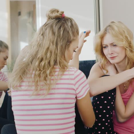 young woman comforts and supports his girlfriend who is upset and crying