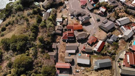 Slow-overhead-flight-over-typical-small-village-in-Japan-to-beach