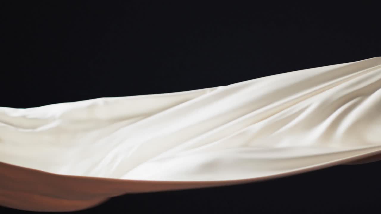 검은색 배경 위에 복사 공간과 함께  ⁇ 색 천을 불어 넣는 애니메이션