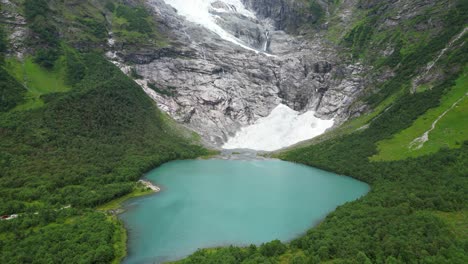 jostedalsbreen glacier norway - boyabreen viewpoint and turquoise blue glacial lake - aerial tilting up