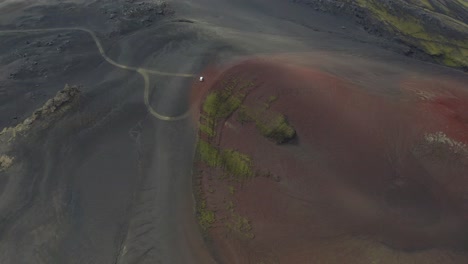 Aerial-tilt-up-shot-showing-red-crater-and-hekla-volcano-in-Icelandic-highlands