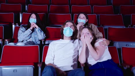 moviegoers wearing masks in a theater