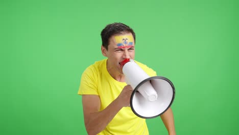 excited man with ecuadorian flag on face using a megaphone
