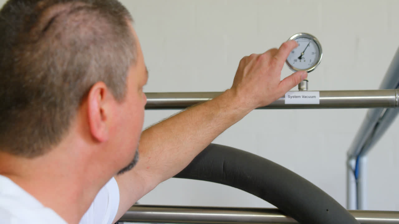 trabajador masculino comprobando el nivel de medición de la destilación 4k