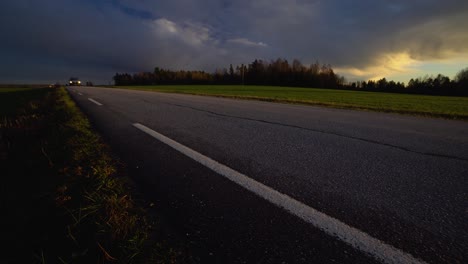 car passing by in the sunset. quick pan