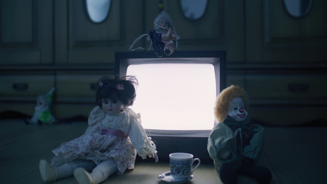 Vintage Dolls and Clowns Beside a Retro TV