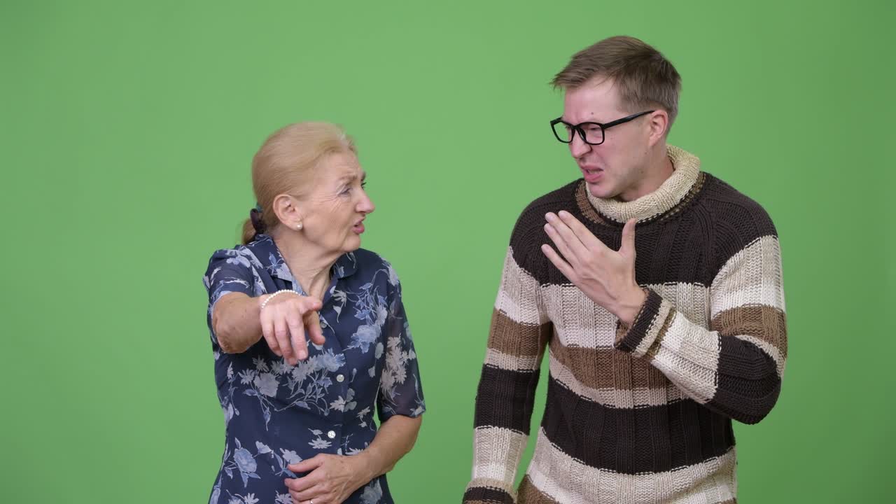 Grandmother and grandson looking shocked while pointing finger together
