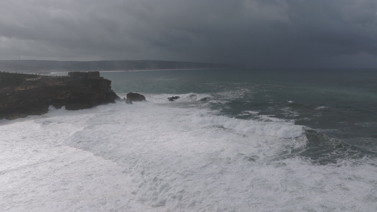 Giant ocean waves at famous iconic Nazaré, aerial drone shot. Portugal, Europe