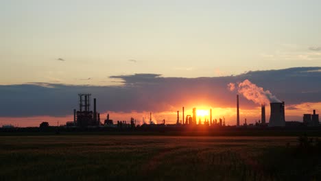 wide shot of spectacular sunset over oil refinery, time lapse 4k