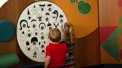 two kids engaged with a circular display