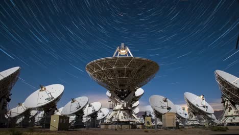 a stunning perspective of satellite dishes capturing the cosmic dance of stars in a starry night sky - an exquisite fusion of technology and nature