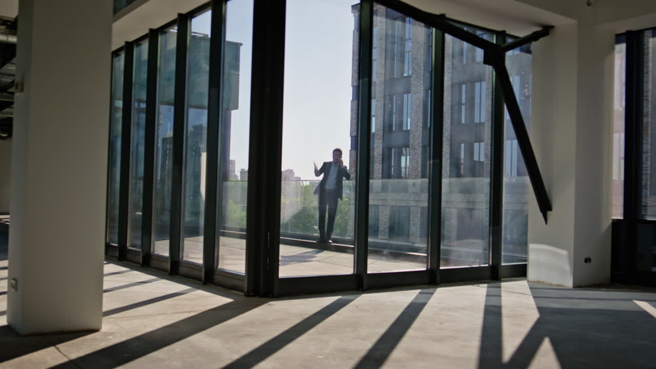 Businessman silhouette talking mobile phone at office terrace. Boss quarrelling