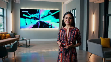Professional Woman Presenting in Modern Studio with Digital Display