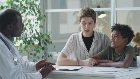 a doctor consulting with a child and their mother