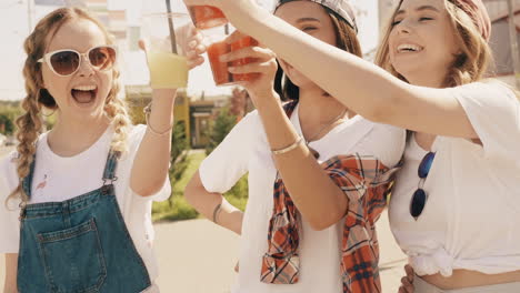 three friends enjoying drinks outdoors