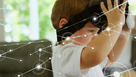 animation of communication network over caucasian boy using vr headset at home