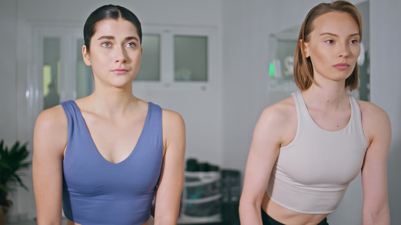 Focused women sport training white house closeup. Athlete girls fitness routine