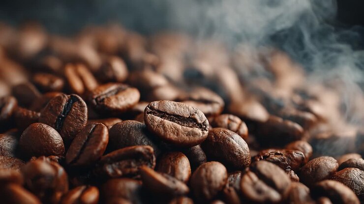 A Captivating Close-Up on Freshly Roasted Coffee Beans, Showcasing Their Rich Aroma and Texture with Subtle Steam Rising in the Air, Perfect for Coffee Enthusiasts and Connoisseurs