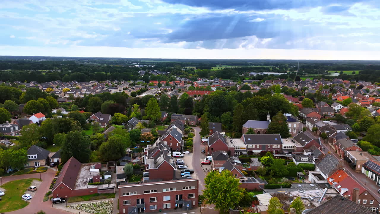 Lovely residential houses with lush greenery around. Panorama of picturesque town of Vierlingsbeek, Netherlands. Aerial view